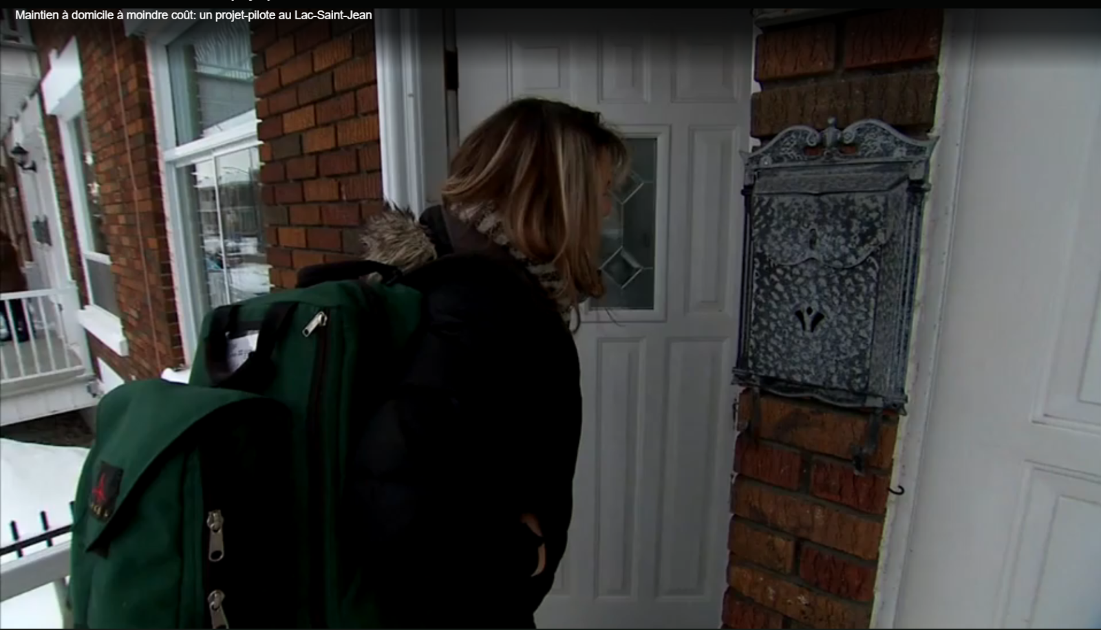 Femme à la porte d'une maison